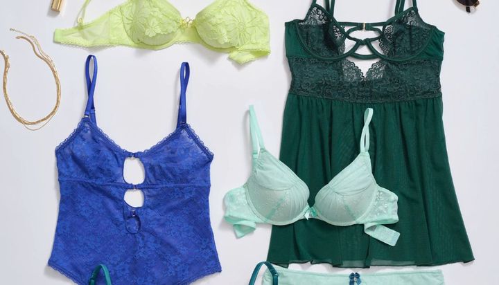 A flat lay of colorful lingerie, including bras and bodysuits.