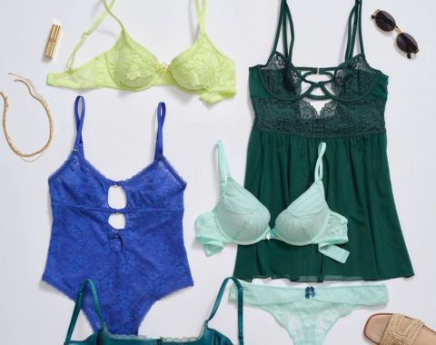 Flat lay of colorful lingerie, including bras, panties, a teddy, and a babydoll.
