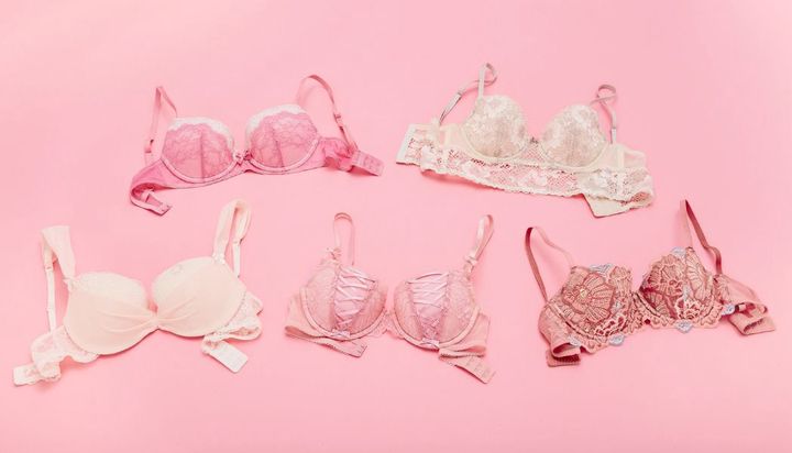 A collection of lace bras in various shades of pink and beige.