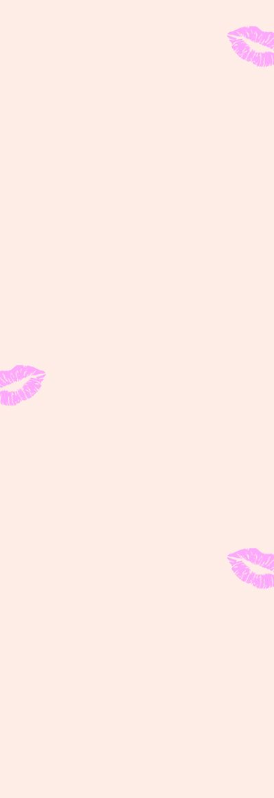 Pink lipstick kisses on a pale pink background.