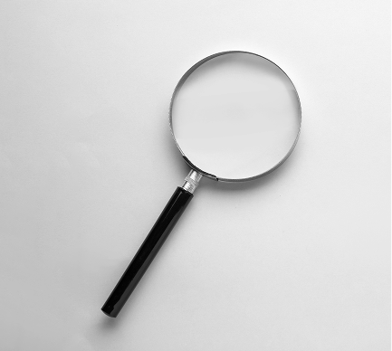 Magnifying glass with a black handle and a silver frame.