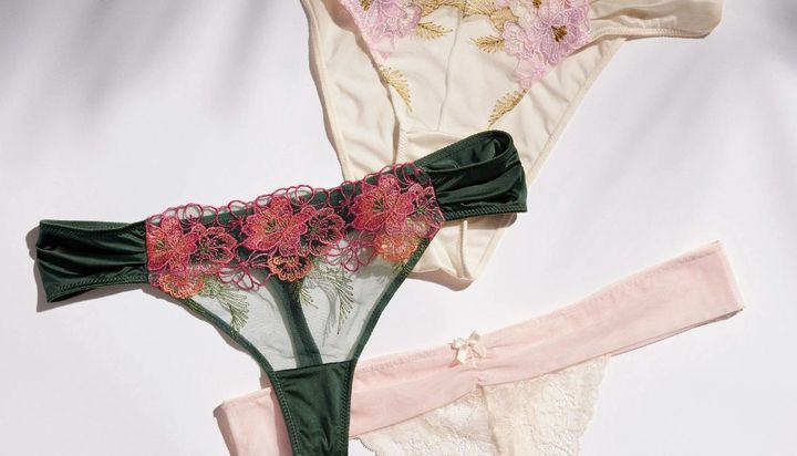 Three pairs of thong underwear in various pastel colors and floral designs.