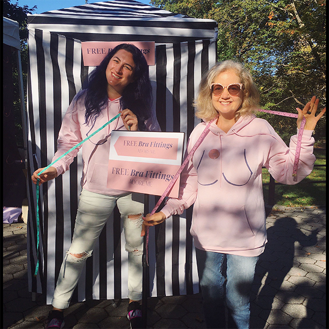 Pink hoodies promoting free bra fittings.