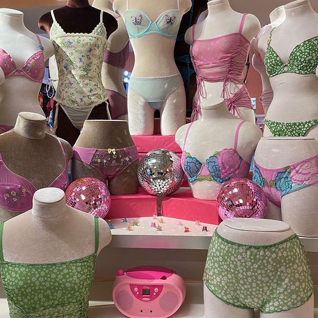 Lingerie display featuring bras, panties, disco balls, and a pink boombox.
