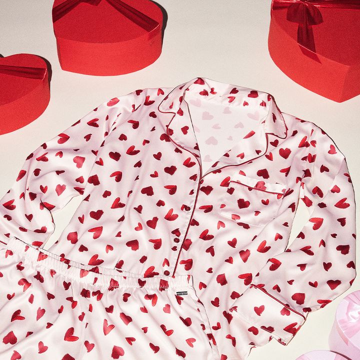 Pink pajamas with red hearts, surrounded by red heart-shaped boxes.