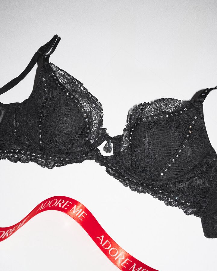 Black lace bra with rhinestones and "ADORE ME" red ribbon.