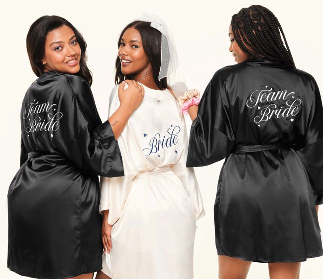 Three women in satin robes with "Team Bride" and "Bride" text.